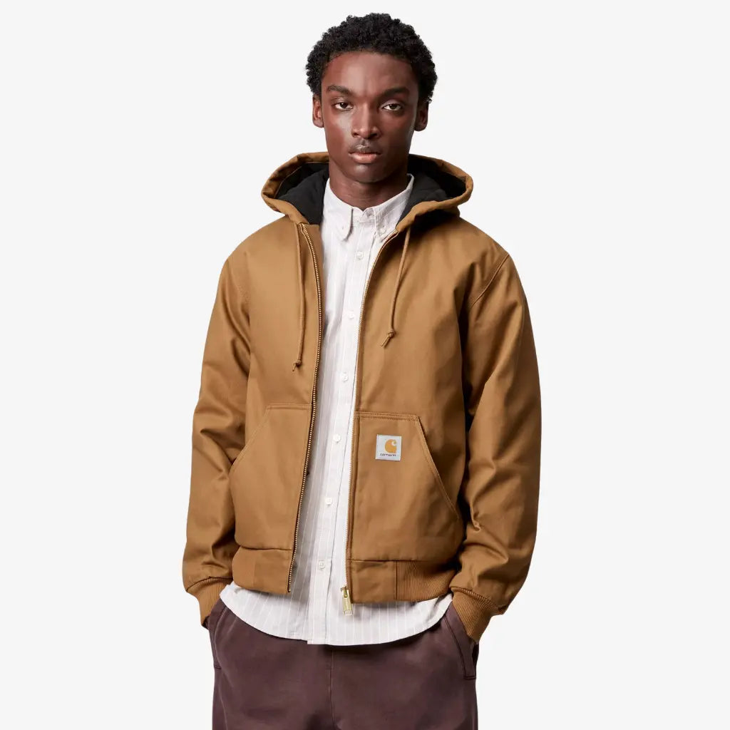 Veste Active Winter Carhartt WIP Hamilton Brown Rigid portée ouverte sur une chemise blanche, étiquette carrée sur la poche