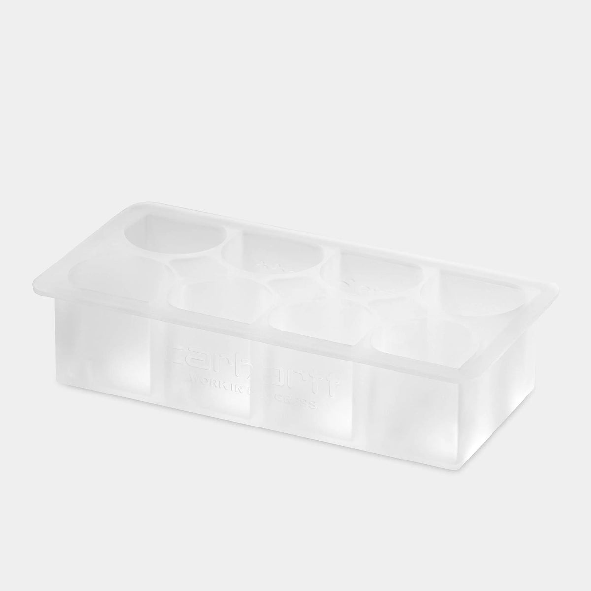 Bac à glaçons en silicone translucide vu de trois-quarts, alvéoles vides et marquage en relief sur le flanc