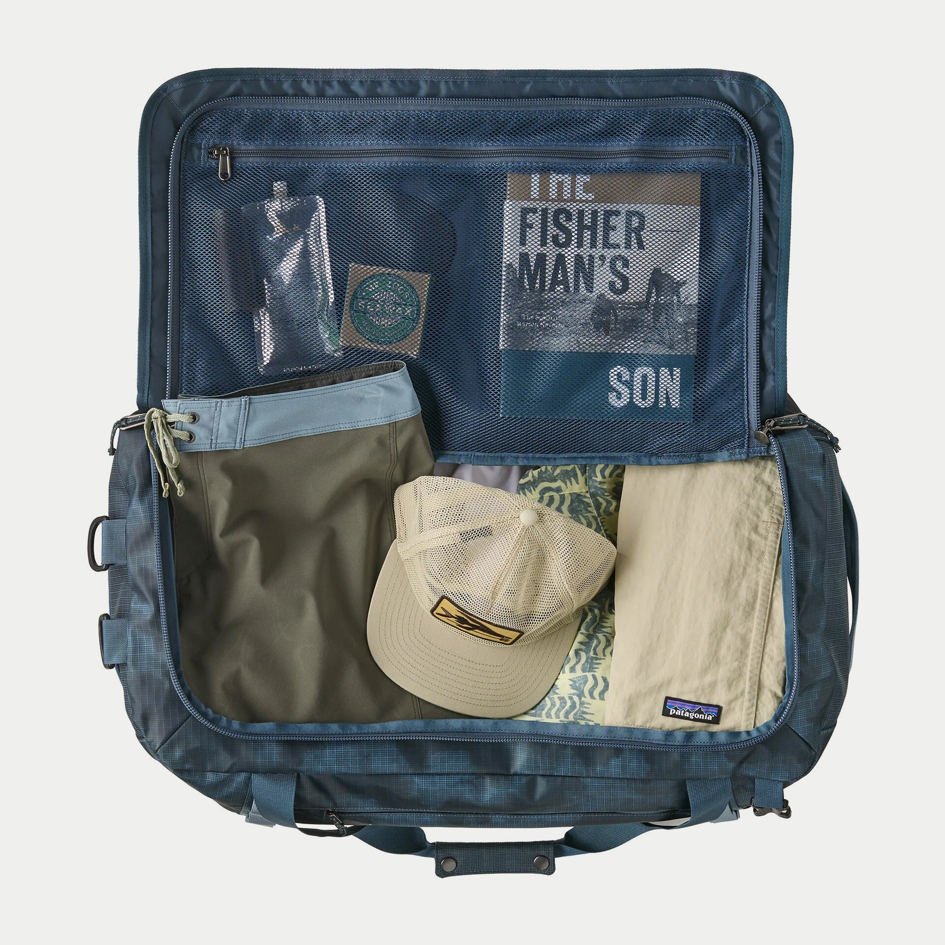 Black Hole Duffel 55L Summit Blue Patagonia ouvert à plat, intérieur bleu et poche filet zippée dans le couvercle