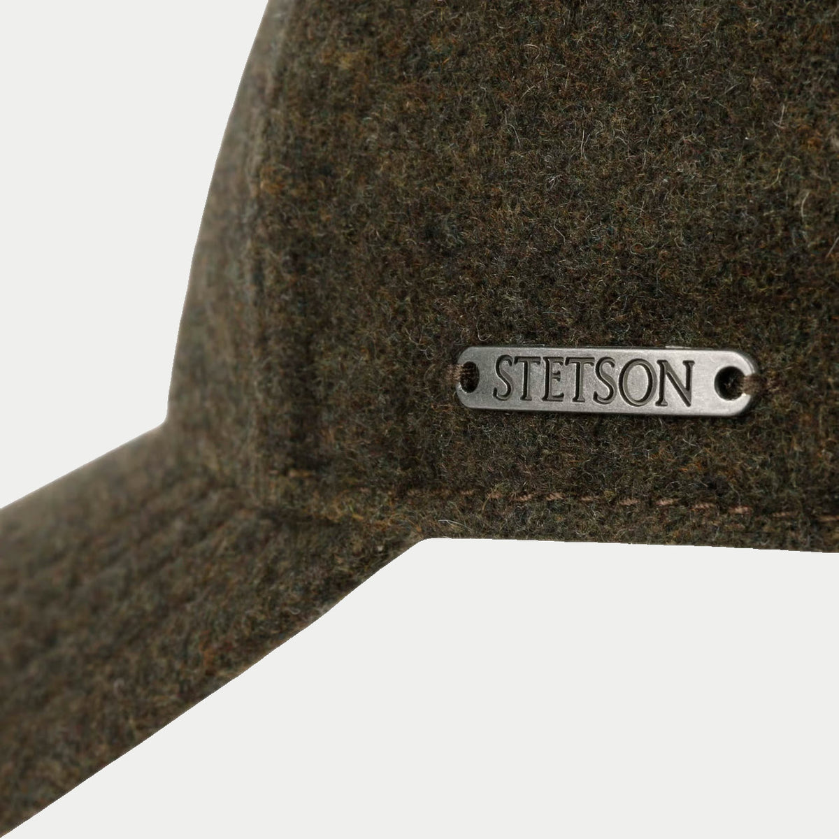 Plaque métal Stetson sur la laine chinée olive de la casquette Vaby, gros plan