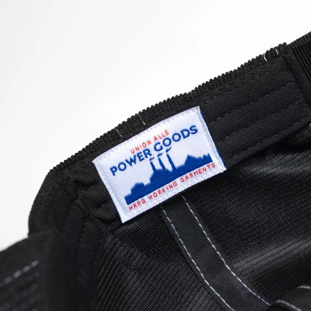 Intérieur noir de la casquette avec étiquette tissée Union Alls Power Goods