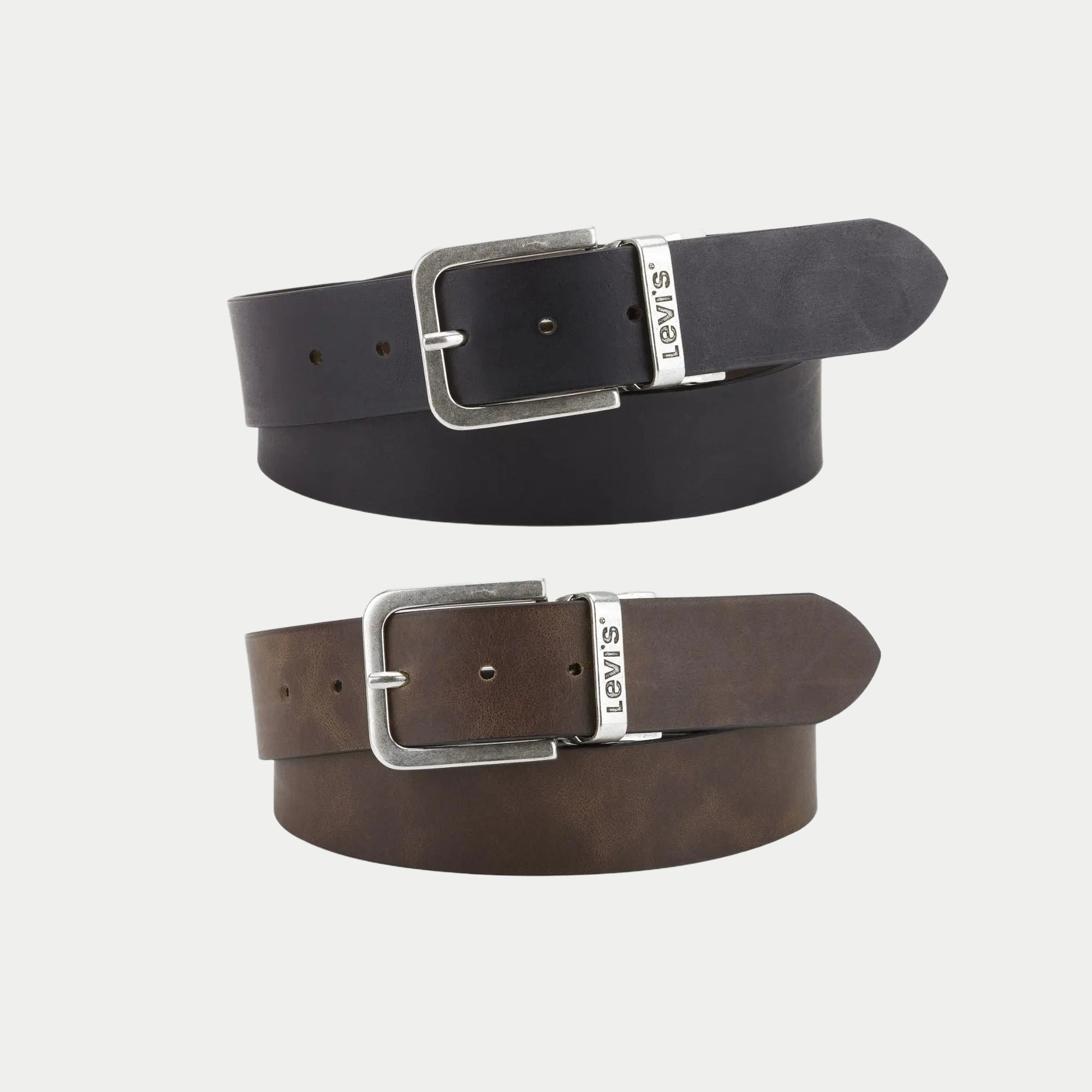 Ceinture Levi's Legacy réversible en cuir : face noire enroulée au-dessus de la face marron, boucle argent vieilli