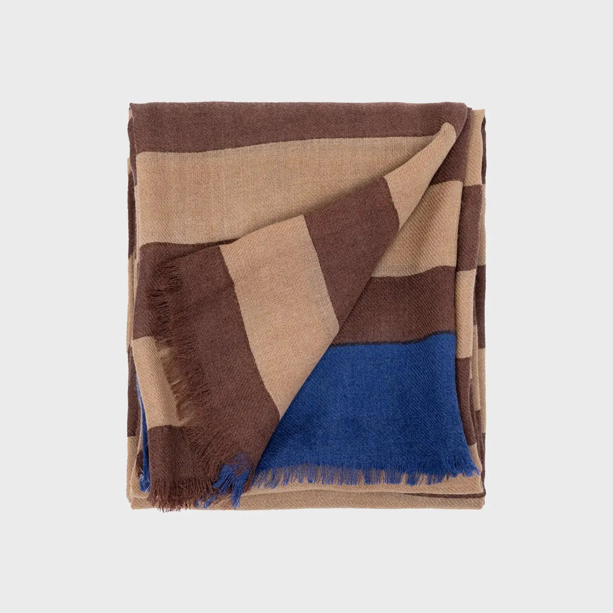 Foulard en laine plié, larges rayures marron chocolat et camel avec un aplat bleu roi en bout de pan