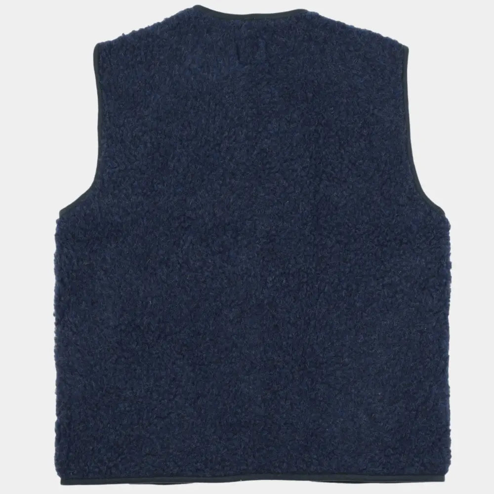 Dos uni du gilet en laine bouclée bleu marine, encolure et emmanchures bordées de gros-grain sombre