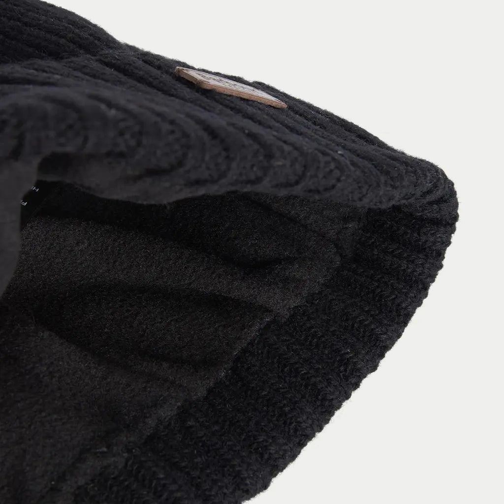 Revers du bonnet Carlton noir retourné, doublure intérieure douce et côtes de la maille apparentes