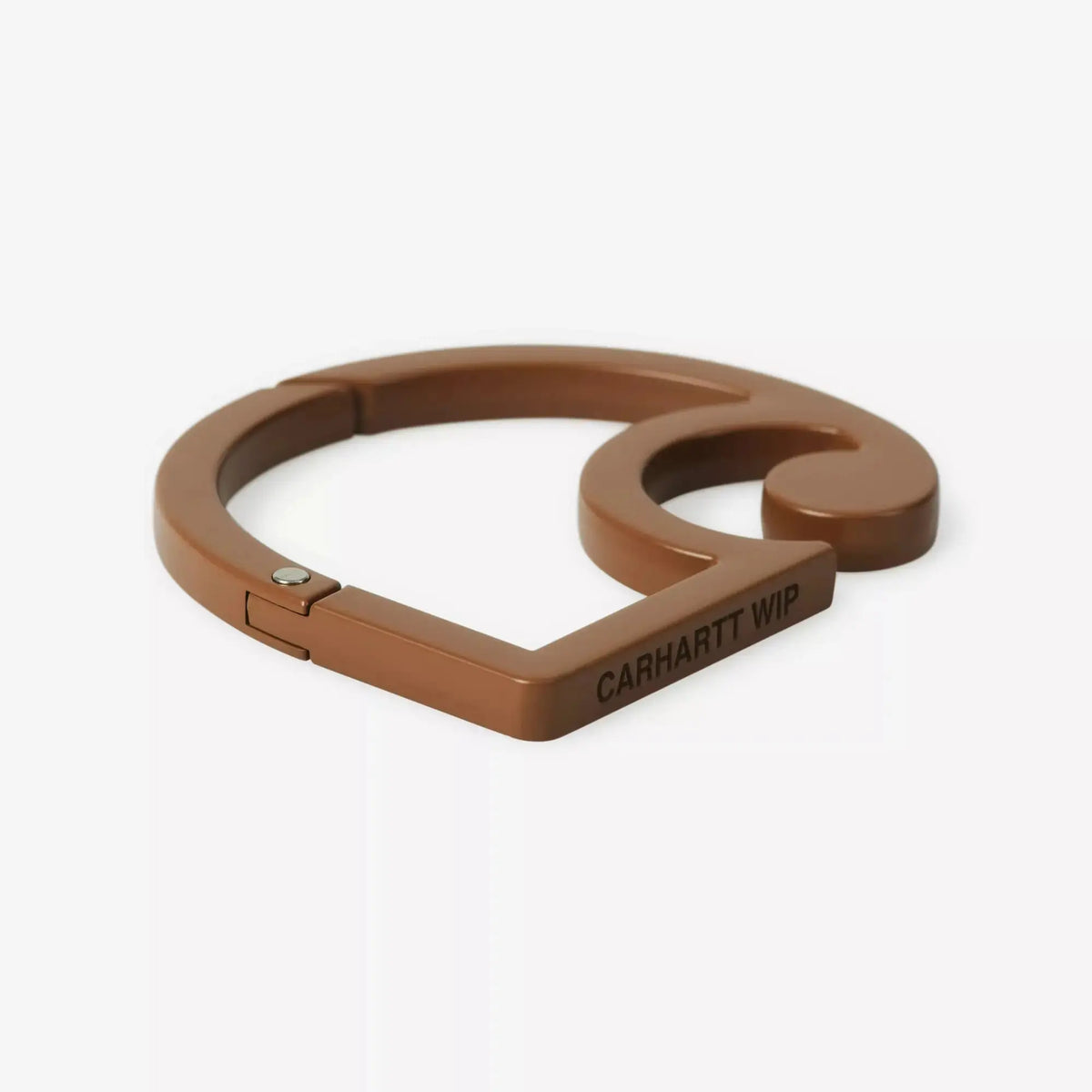 Mousqueton C-logo marron caramel laqué de trois-quarts, arête plate gravée CARHARTT WIP et rivet métal argenté
