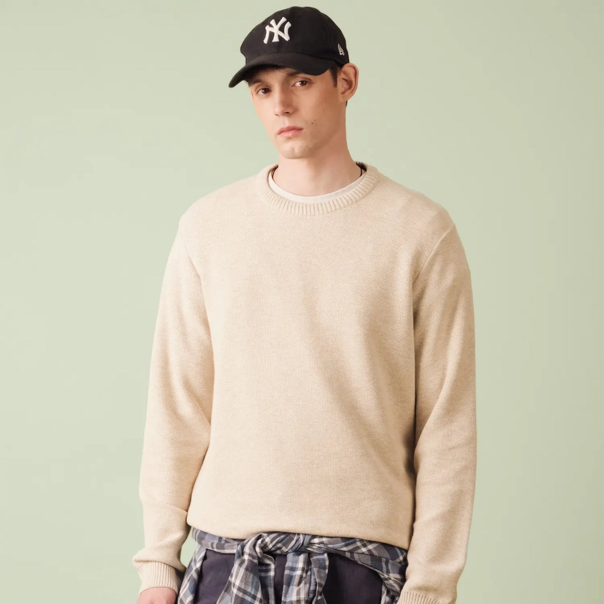 Pull Agop en coton beige chiné porté, vue de face rapprochée sur l'encolure ronde et les épaules
