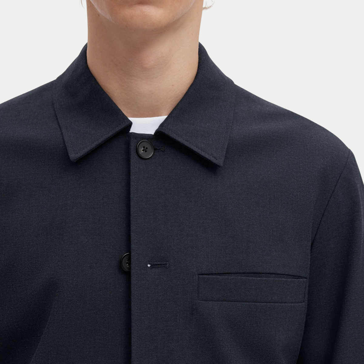 Détail du col chemise, des boutons et de la poche poitrine passepoilée de la surchemise Robert bleu marine