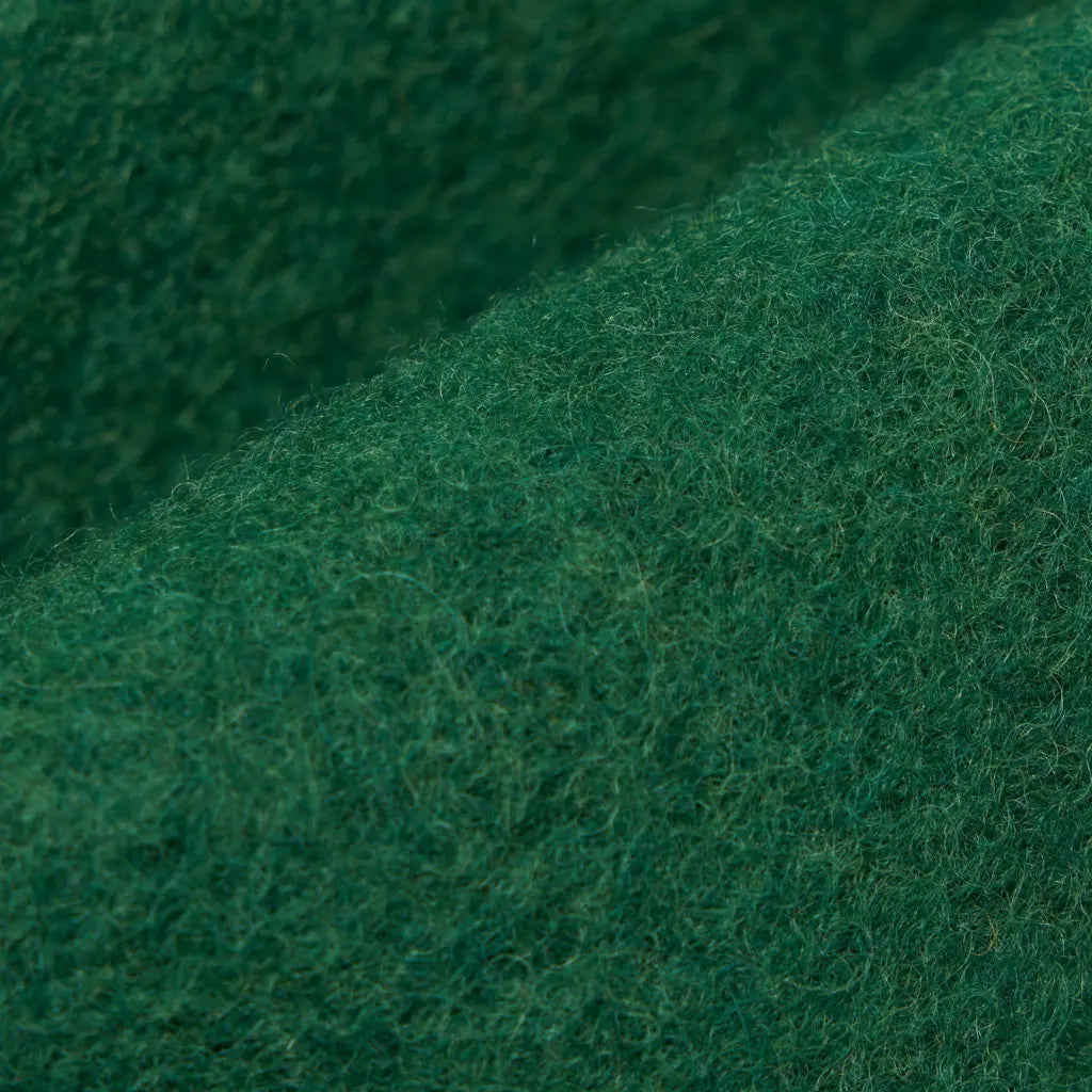 Macro de la laine bouillie verte de la Zip Liner, surface feutrée et duveteuse